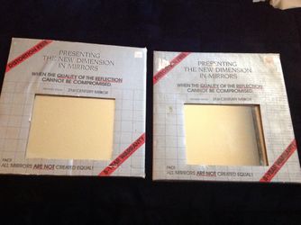 2 Packages of glass wall mirrors - Never used.