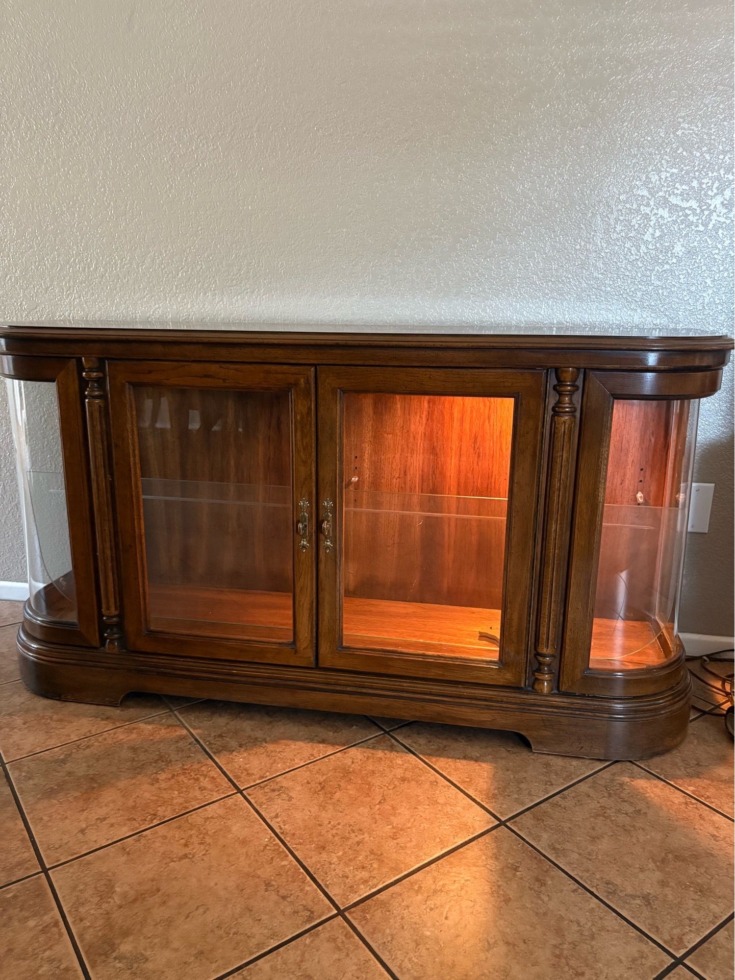 Low entertainment center with a light glass shelves Low entertainment center with a light glass shelves