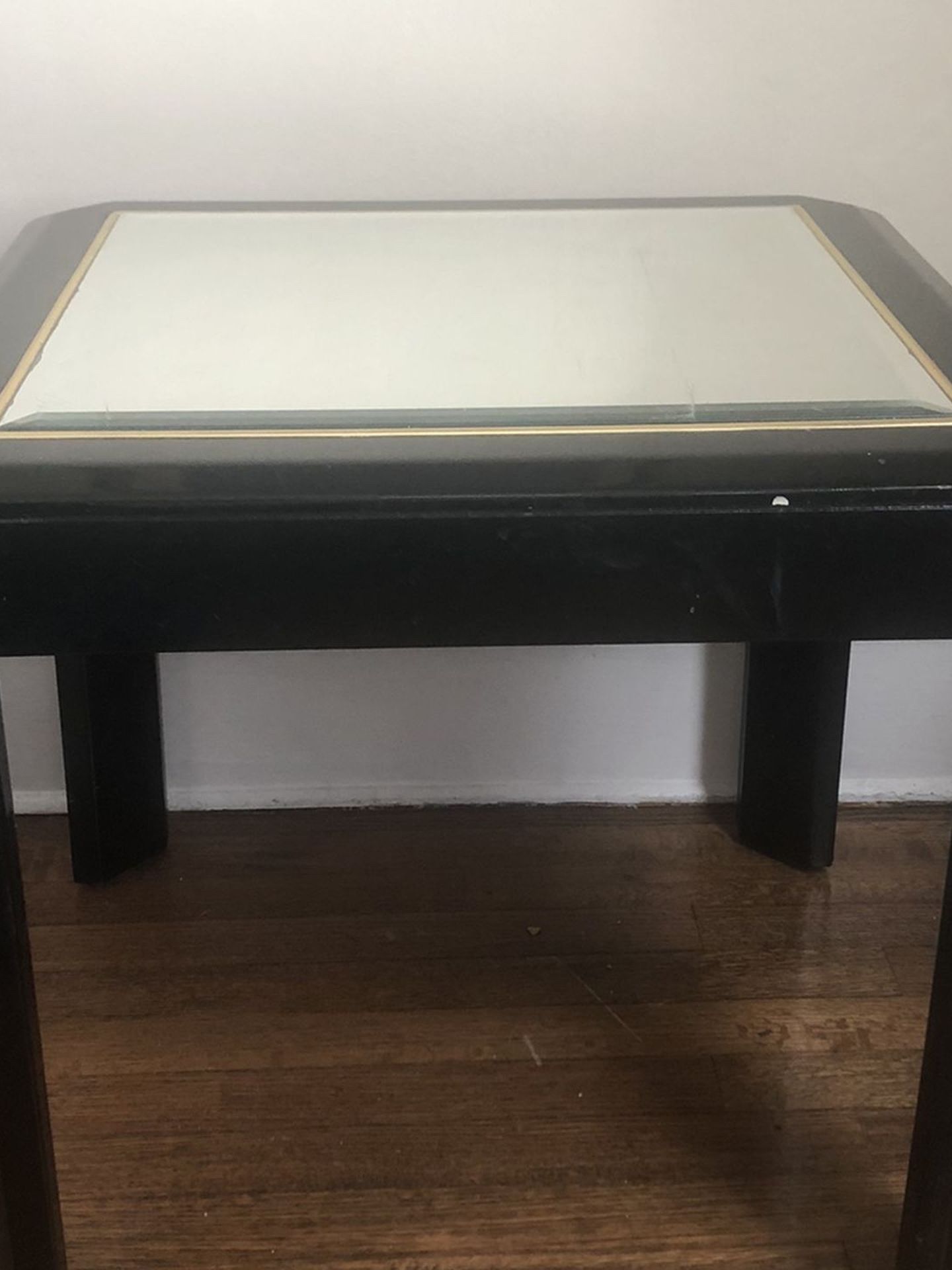 Not sold! Two black tables with glass tops.