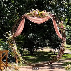 Wooden arch backdrop with faux wildflowers