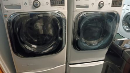 White LG Steam Washer + Gas Dryer Pair on Pedestals
