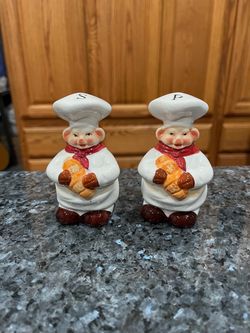 Vintage Ceramic Chef Pig Pair of Salt and Pepper Shakers.  Size approximately 4 inches tall.  Preowned.  Has been on display in a cabinet with a very 