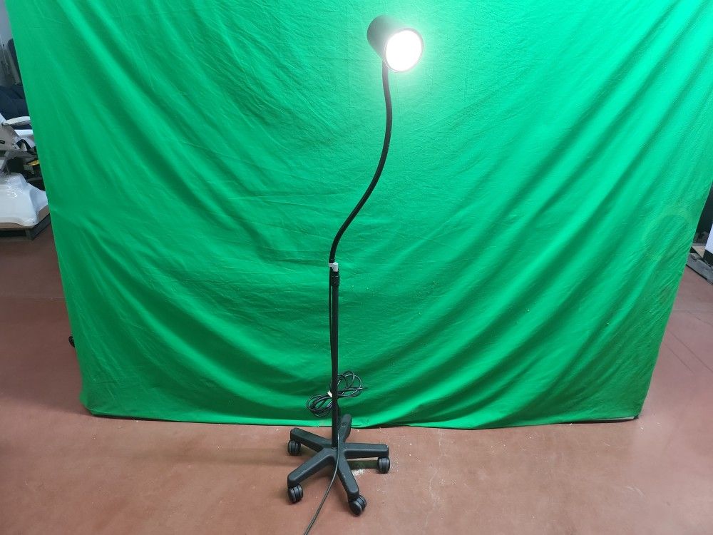 Adjustable gooseneck exam light on wheels.