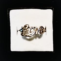 Silver ring with 'Love' design.   $5
