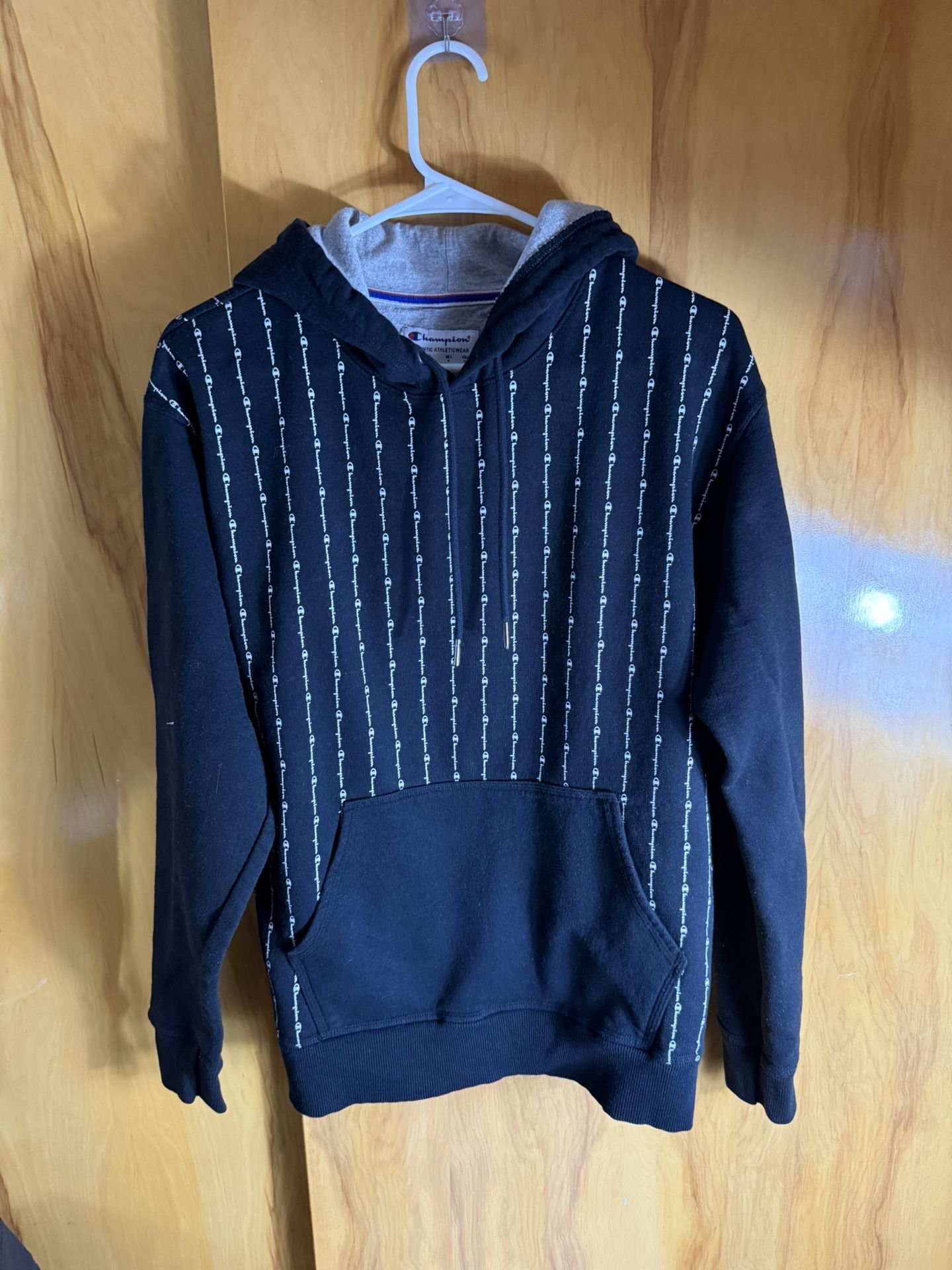 black Champion Powerblend pullover hoodie with an all-over vertical logo pinstripe design