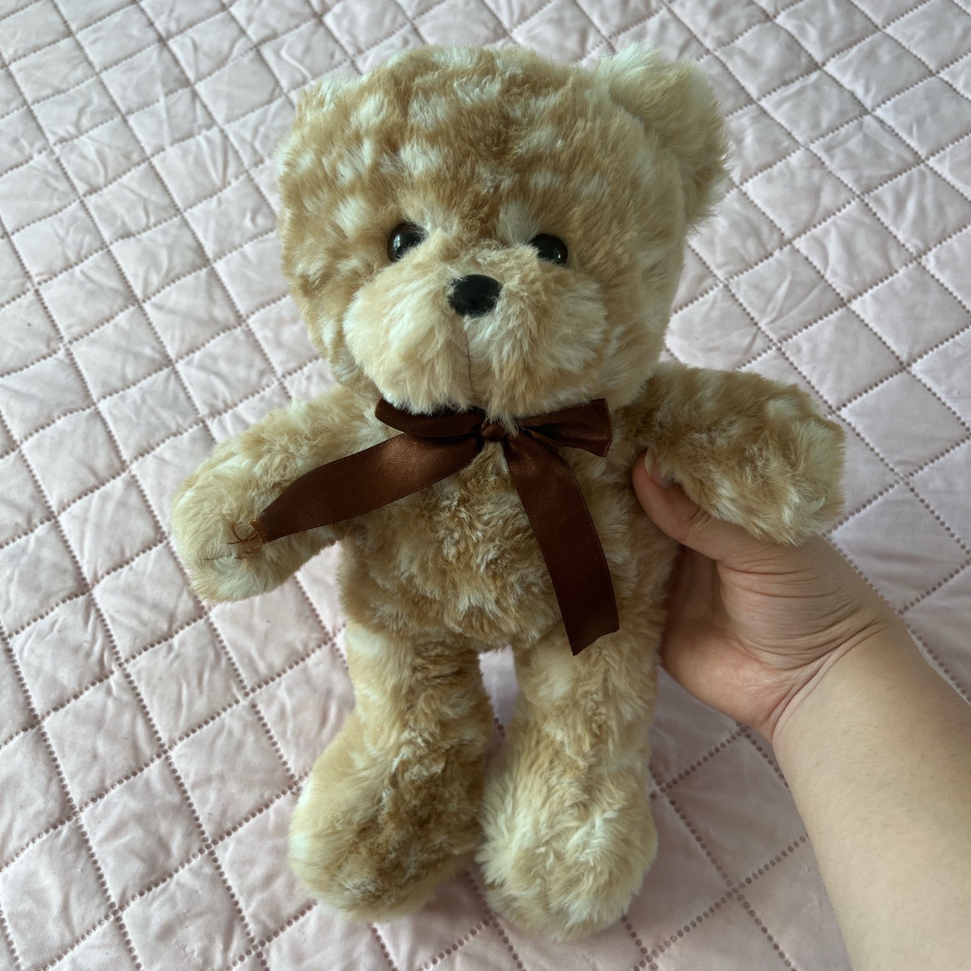 Tan and cream teddy bear with brown ribbon