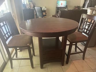 High top dark wooden table with chairs