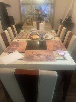 8 person beige and brown dining room with china