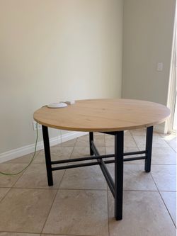 Round table with light wood color top