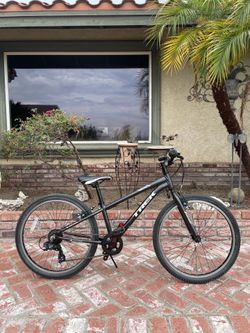 Black Trek Precaliber 24” kids bike.