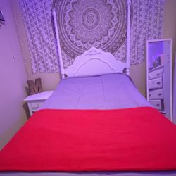 White twin sized bed with nightstand. Includes boxspring and mattress