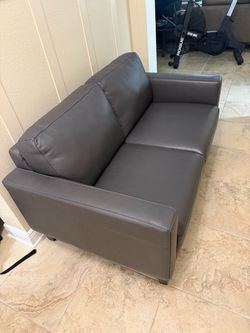 Gray leather loveseat