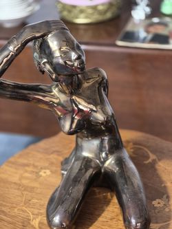 Beautiful solid casted naked woman statue.