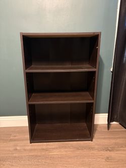 Brown bookshelf with stickers 