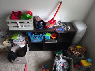 Two cubby shelves with pull out grey boxes 