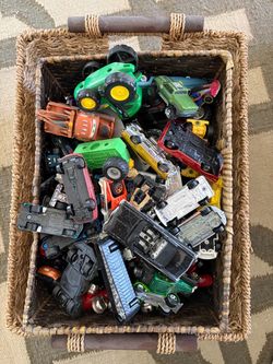 Basket of hot wheels and other toy cars.