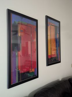 Two large black framed abstract multi-color artwork