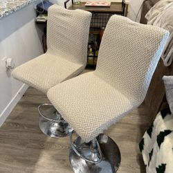 2 leather bar stools with fabric covers