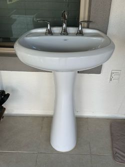 Vortens Sink with Silver Faucet and Oval Mirror