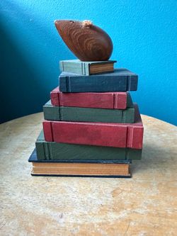 Stack of Vintage Books with Wooden Mouse