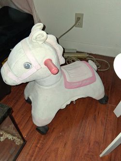 Kids roll around. Riding horse on wheels