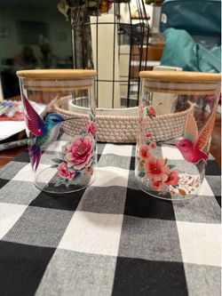 2 Hummingbird glass canisters.