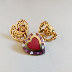 Set of 3 Vintage Gold Toned Heart Brooch Lapel Pins. Two with red heart inlay and one with a rose design. Fashionable Costume Jewelry. Pre-owned in ex