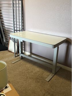 Adjustable white standing desk with glass top Adjustable white standing desk with glass top