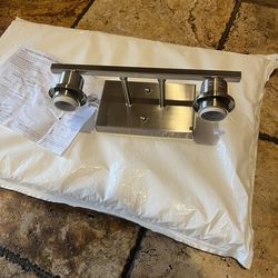 Enhance your home decor with this sleek silver wall light fixture. Its modern design adds a simple classic  touch to any space.  New no light fixture