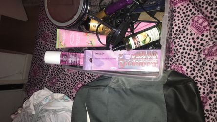 A pink perfume and lotion with realistic press on nails