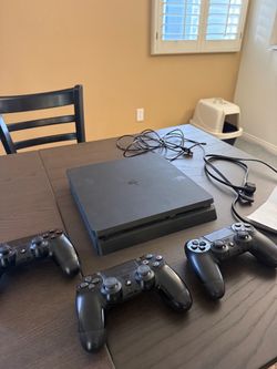 PlayStation 4 console and 3 PlayStation 4 controllers