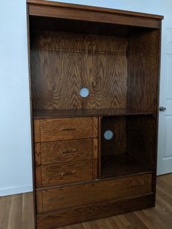 Entertainment center with 3 small drawers 1 large drawer. Drawers work perfectly.
