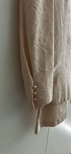 Light pink 2 piece suit with skirt.