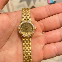 Armitron Now gold-tone women's wrist watch featuring a crystal-accented bezel