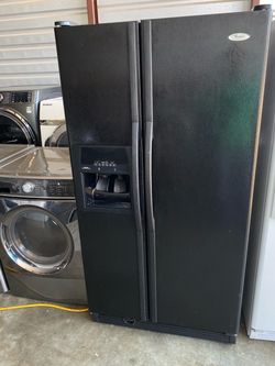 Black color whirlpool refrigerator side by side with ice maker and water dispenser