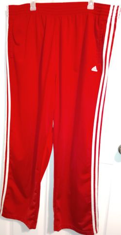 The product is a pair of vintage Adidas Tearaway Track Pants for men in size XL. These wide-leg pants feature a striped pattern with snap buttons and 