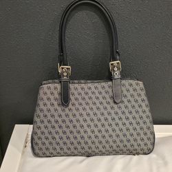 Vintage Y2K women’s black Dooney & Bourke leather and canvas handbag.
