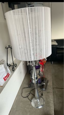 Beautiful elegant floor lamp with a chrome finish, crystal accents, and a white textured fabric shade. Very stylish and perfect for a living room, bed