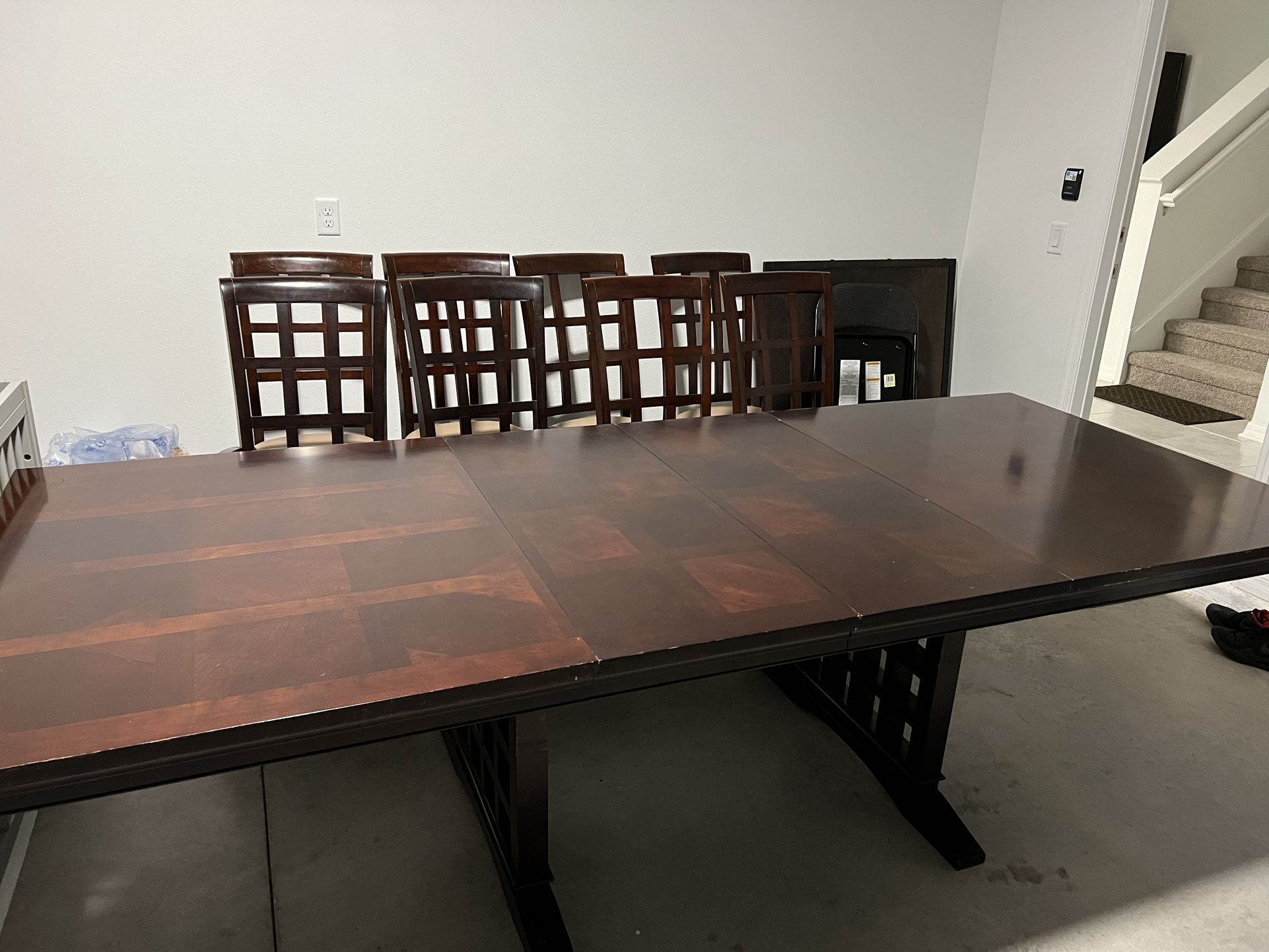 Large dinning table with 8 cushioned chairs made with rock solid,brown colour