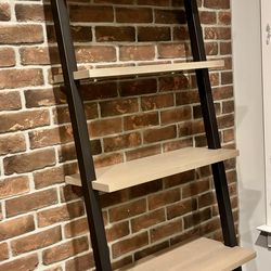 2 leaning bookshelves