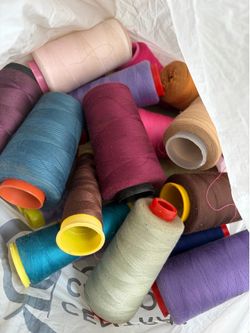Grocery bag full of sewing thread