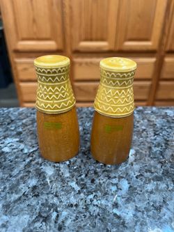 MCM Vintage Mid Century Wood Base Ceramic Top Pair of Salt and Pepper Shakers.  Preowned never used.  Has been on display in a cabinet with a very lar