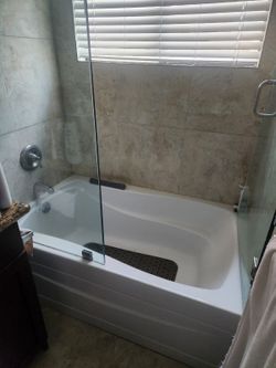 Custom above tub half inch glass enclosure and door with all hardware