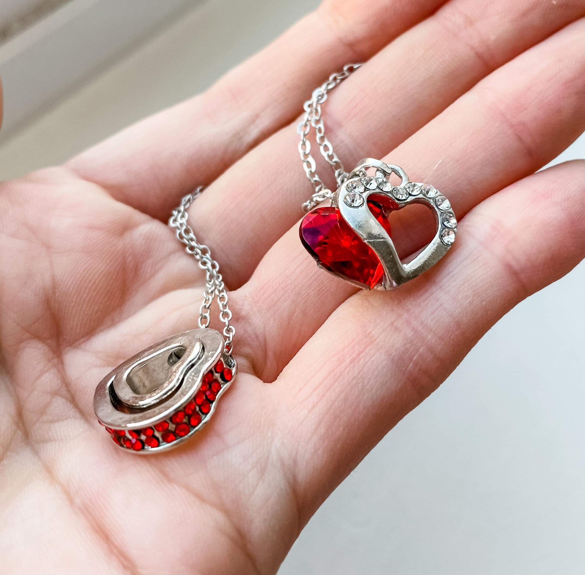 Two silver necklaces with red gemstones