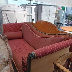 American Empire or Victorian-style sofa featuring a carved mahogany frame and red striped upholstery $500  OBO