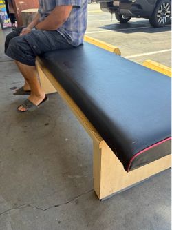 Tan wood sturdy bench with removable cushion topper