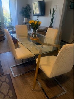 Dining set of 4 - stylish white plastic chairs with glass table.