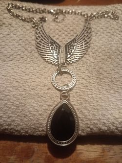 Vintage silver tone angel wings with a black tear drop pendant for sale.