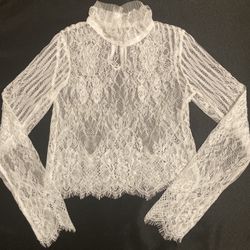 This women’s white all lace long sleeve top in size small is perfect for those looking for a romantic and feminine piece with a cottage core aesthetic