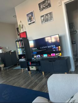 Black tv stand with wooden legs